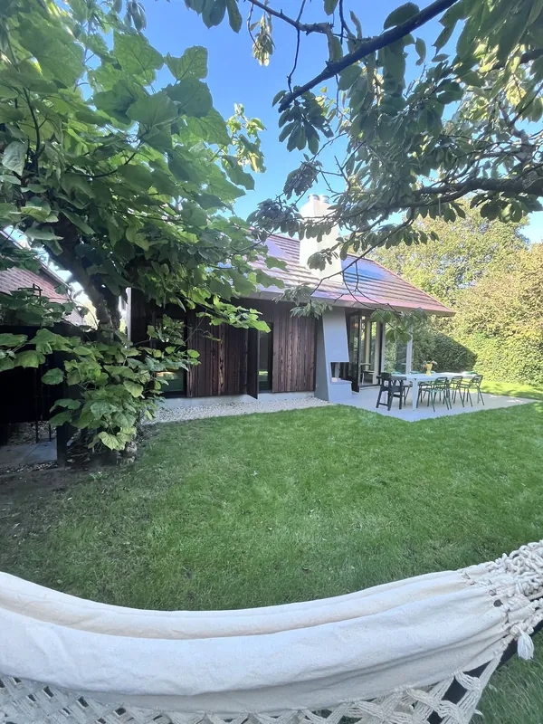 The garden with the house and terrace under the trees